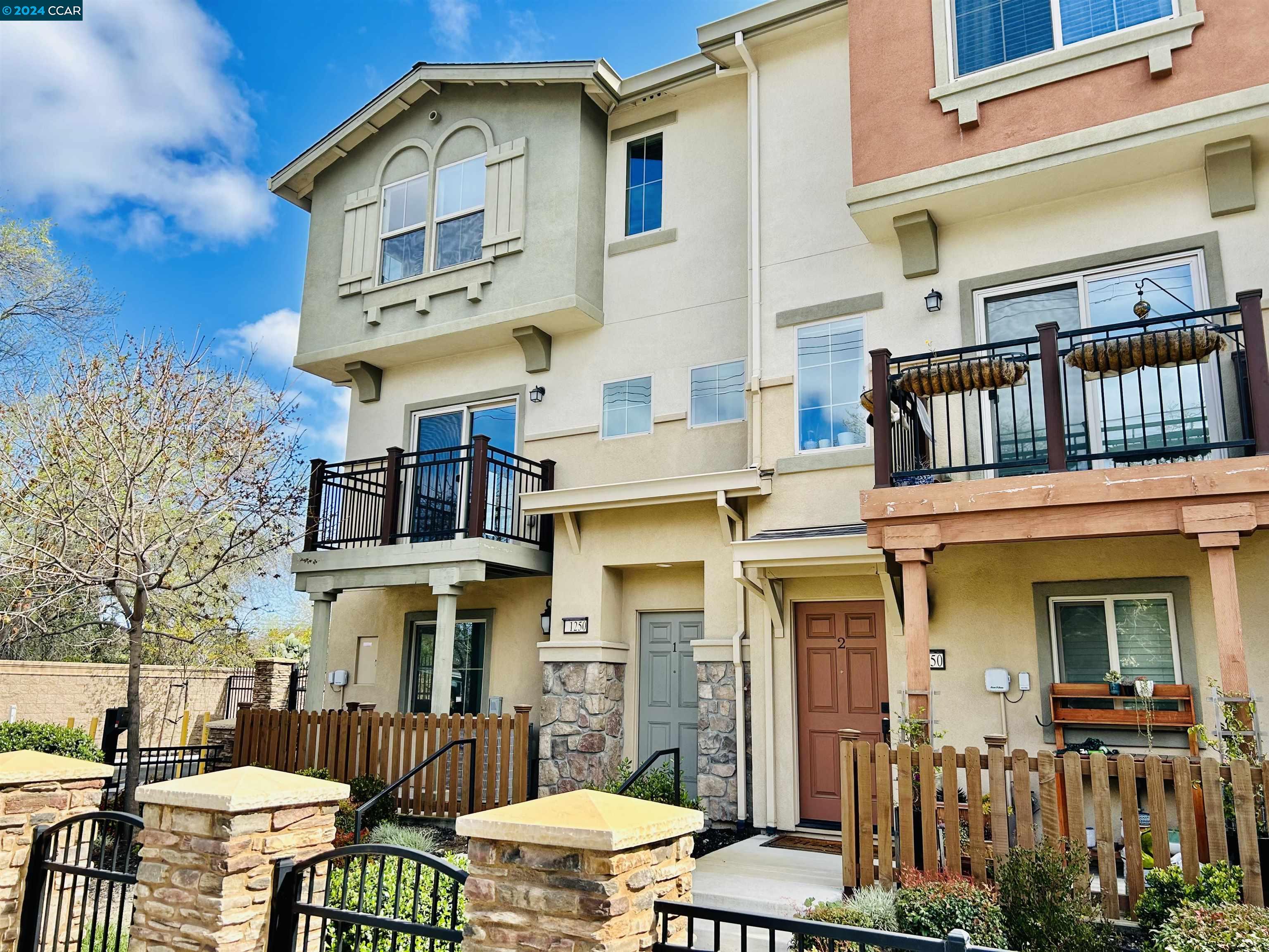 a front view of a residential apartment building with a yard