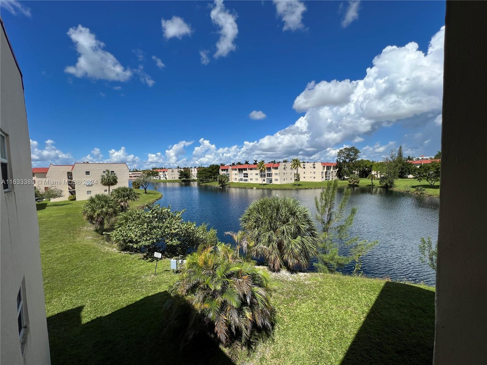 a view of a lake with houses in back