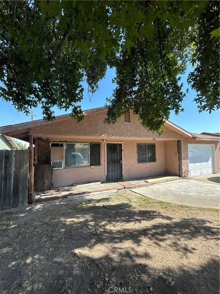 a house that has a tree in front of it