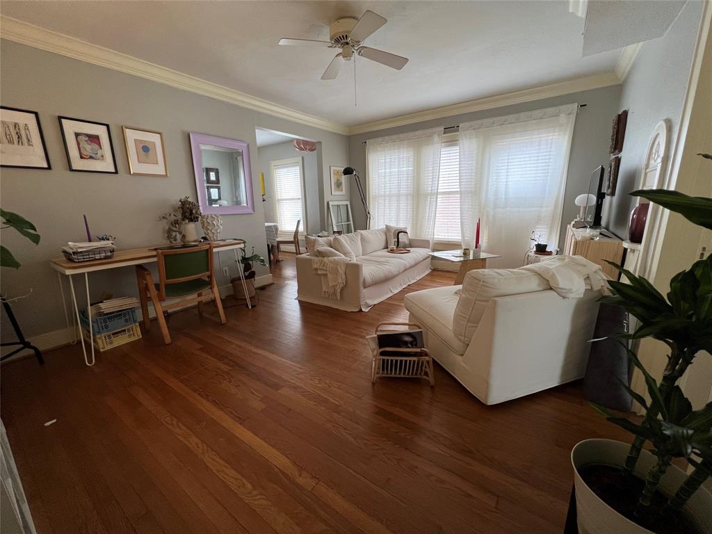 a living room with furniture windows and wooden floor