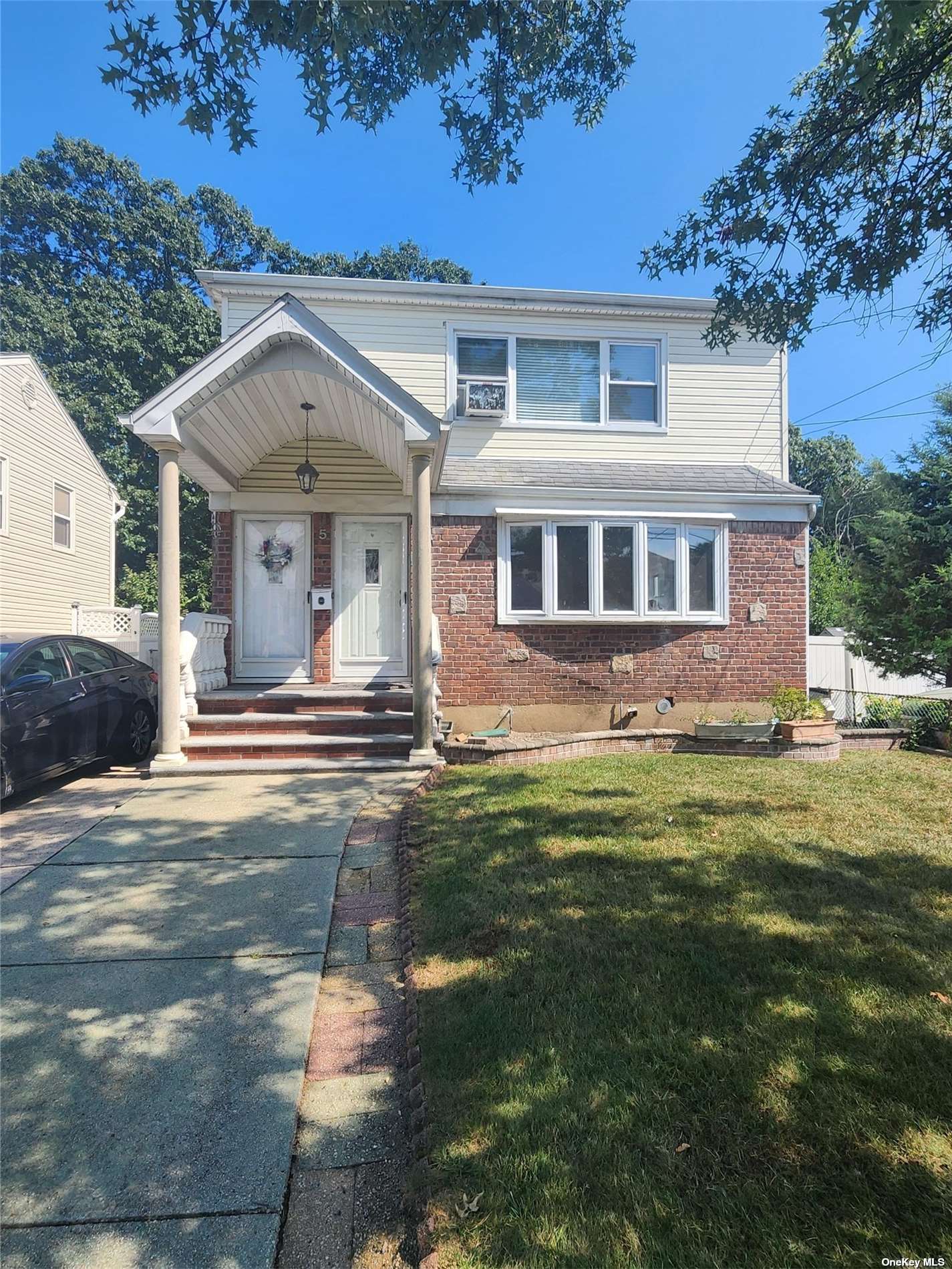 a front view of a house with a garden