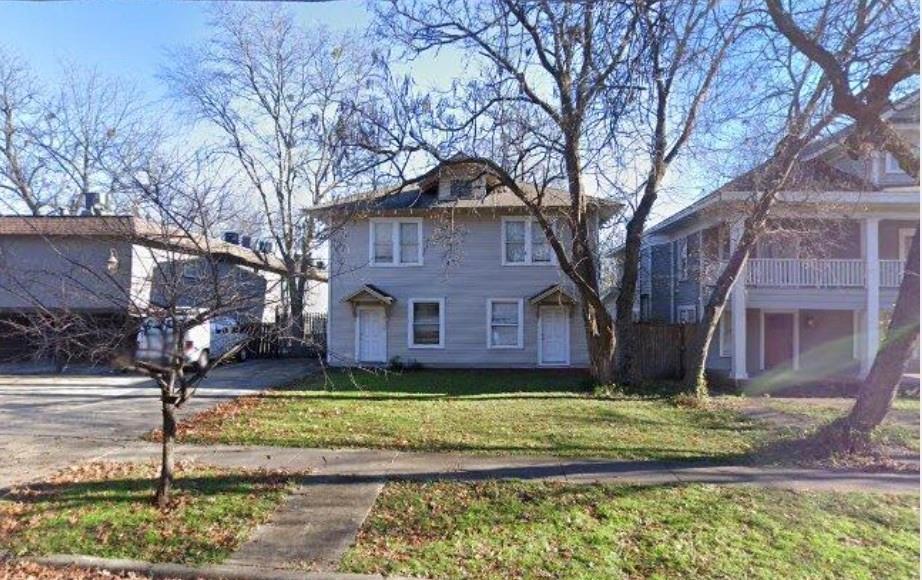 a house that has a tree in front of the house