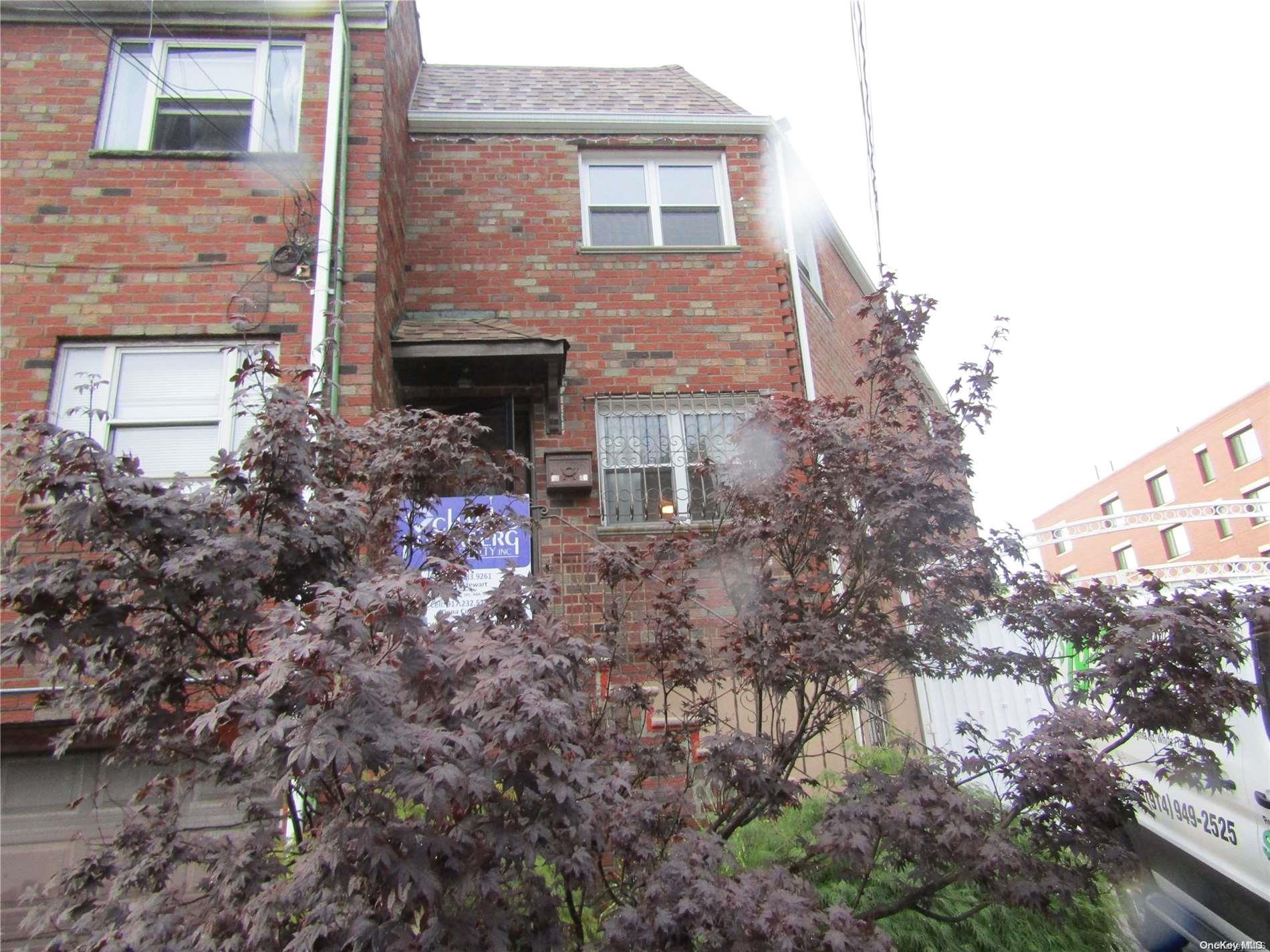 a front view of a house with yard and trees