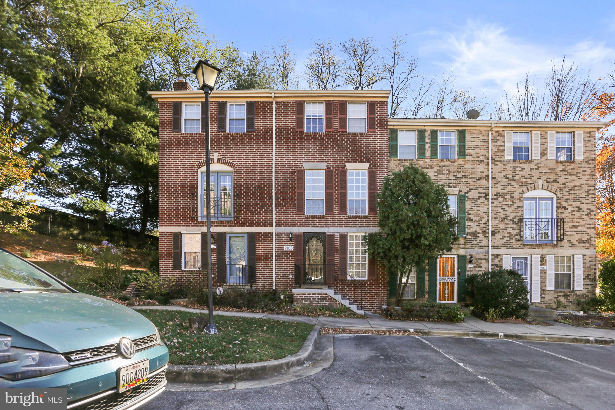 a front view of a residential apartment building with a yard