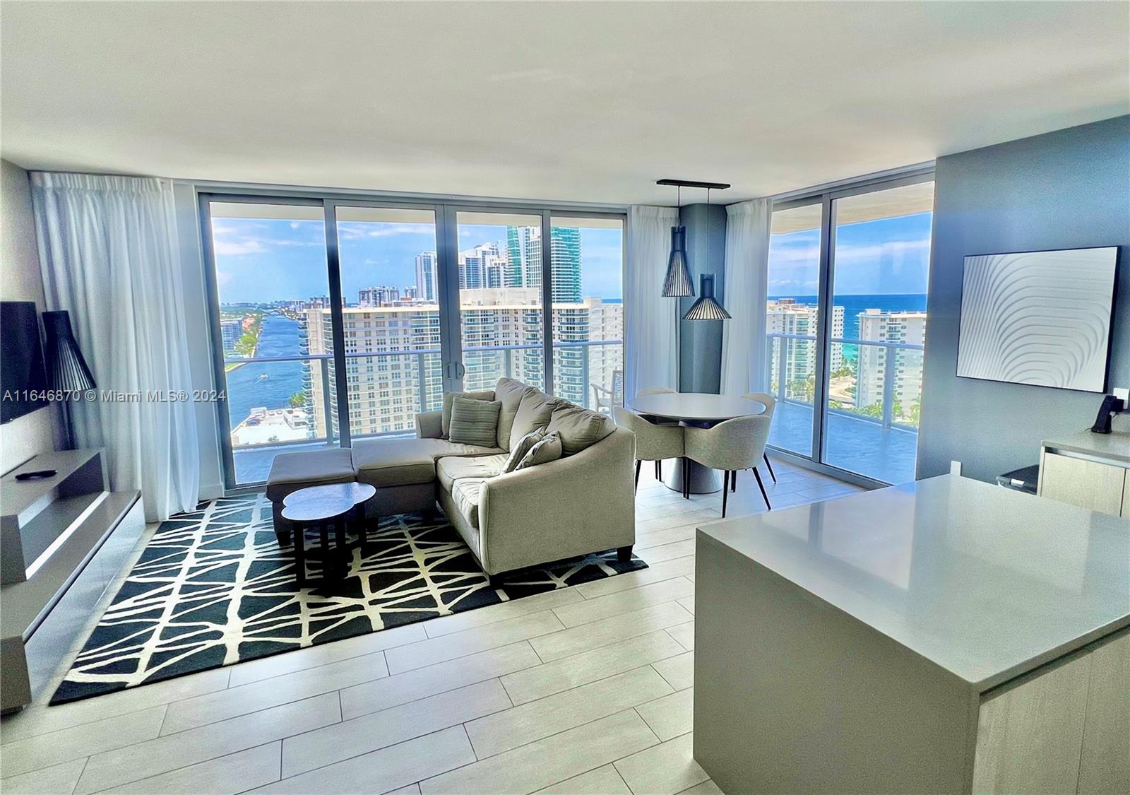 a living room with furniture and large window