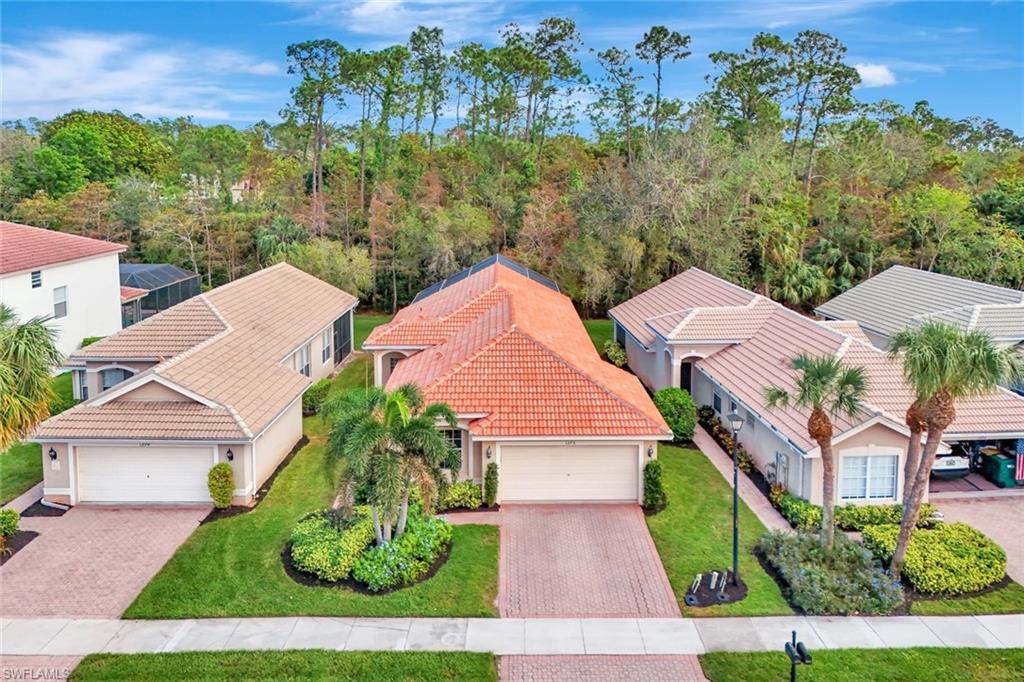 an aerial view of multiple houses with yard