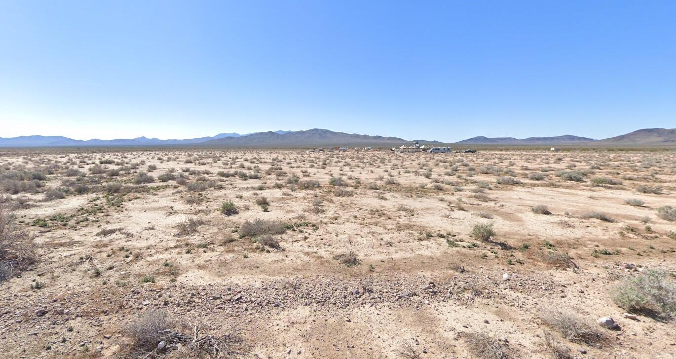 a view of a large mountain with mountains in the background