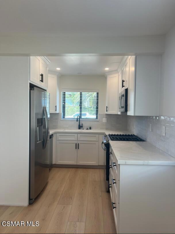 a kitchen with a refrigerator and a sink