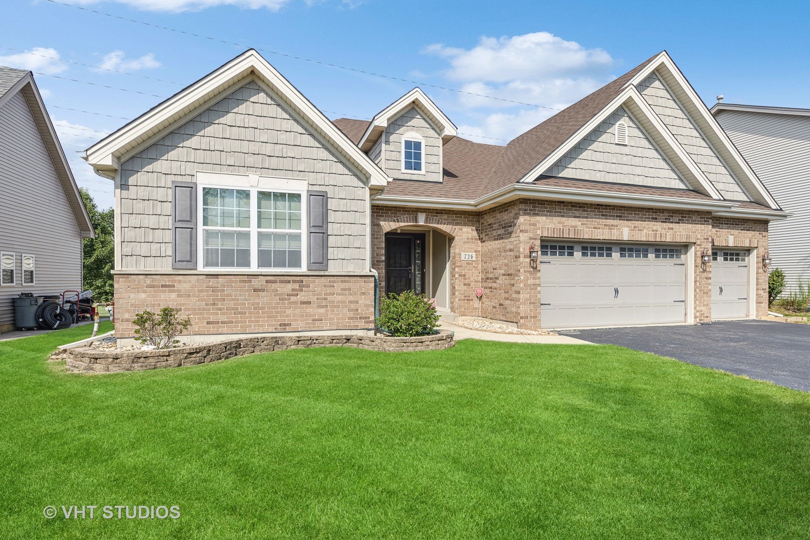 a front view of a house with a yard and garage