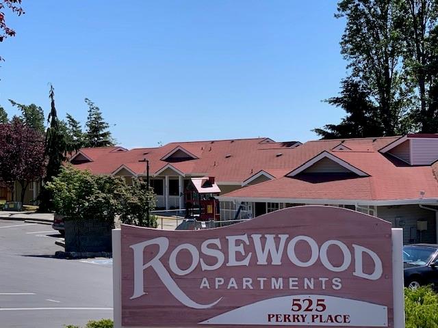 a front view of a house with a sign board