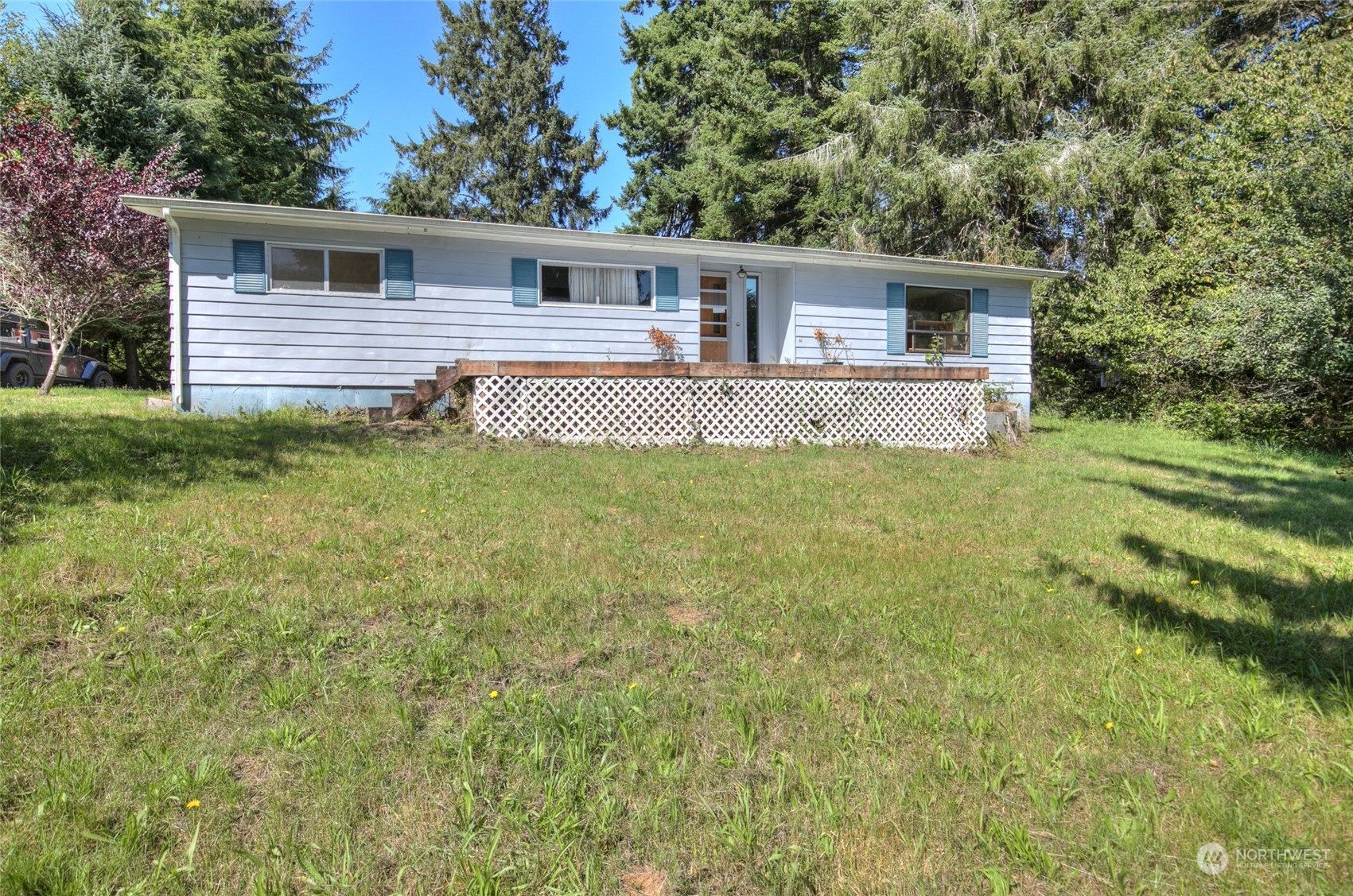 a front view of house with yard and trees