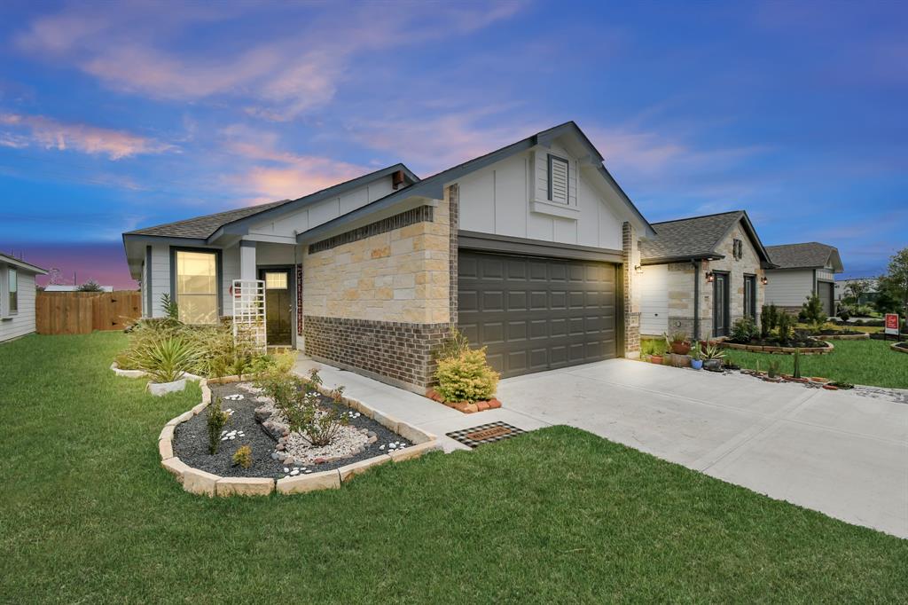 a front view of a house with a yard garage and outdoor seating