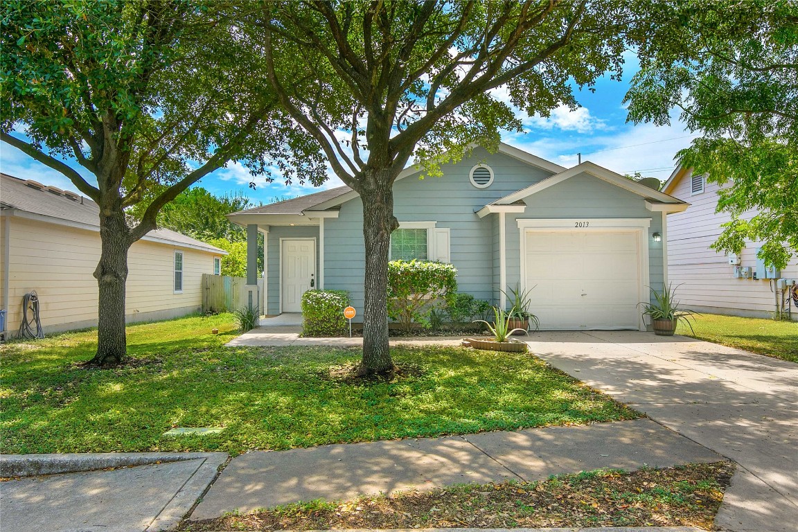 a house that has a tree in front of the house