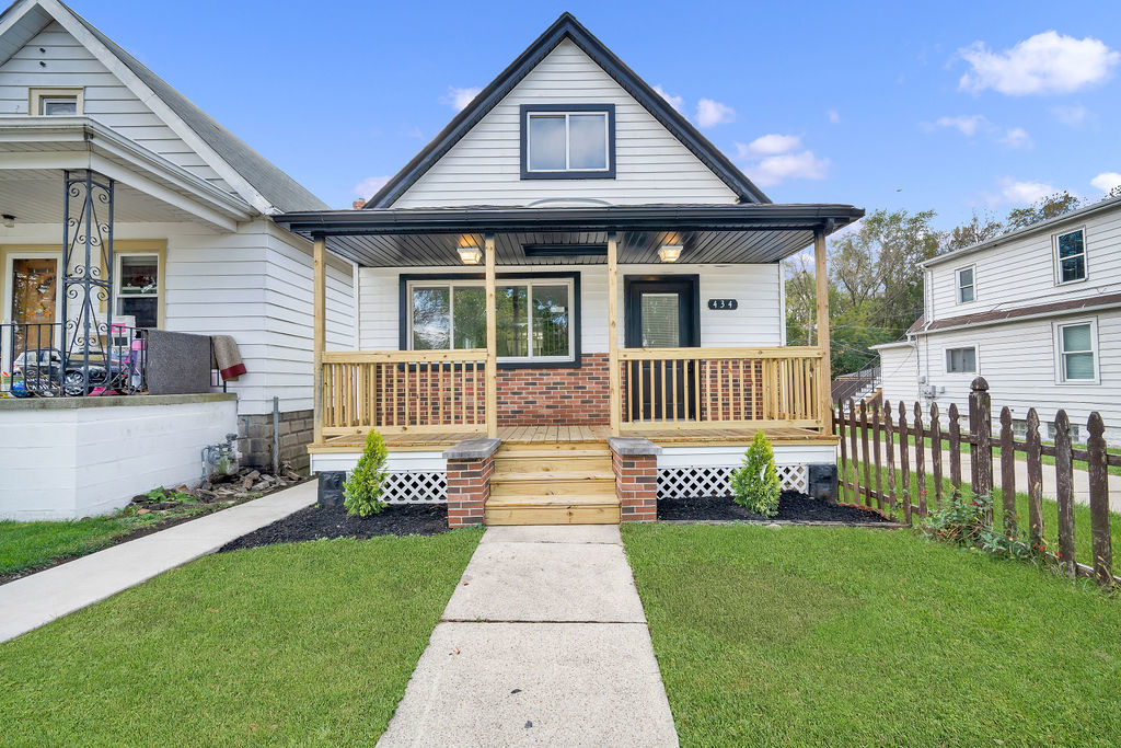 a front view of a house with a garden and porch