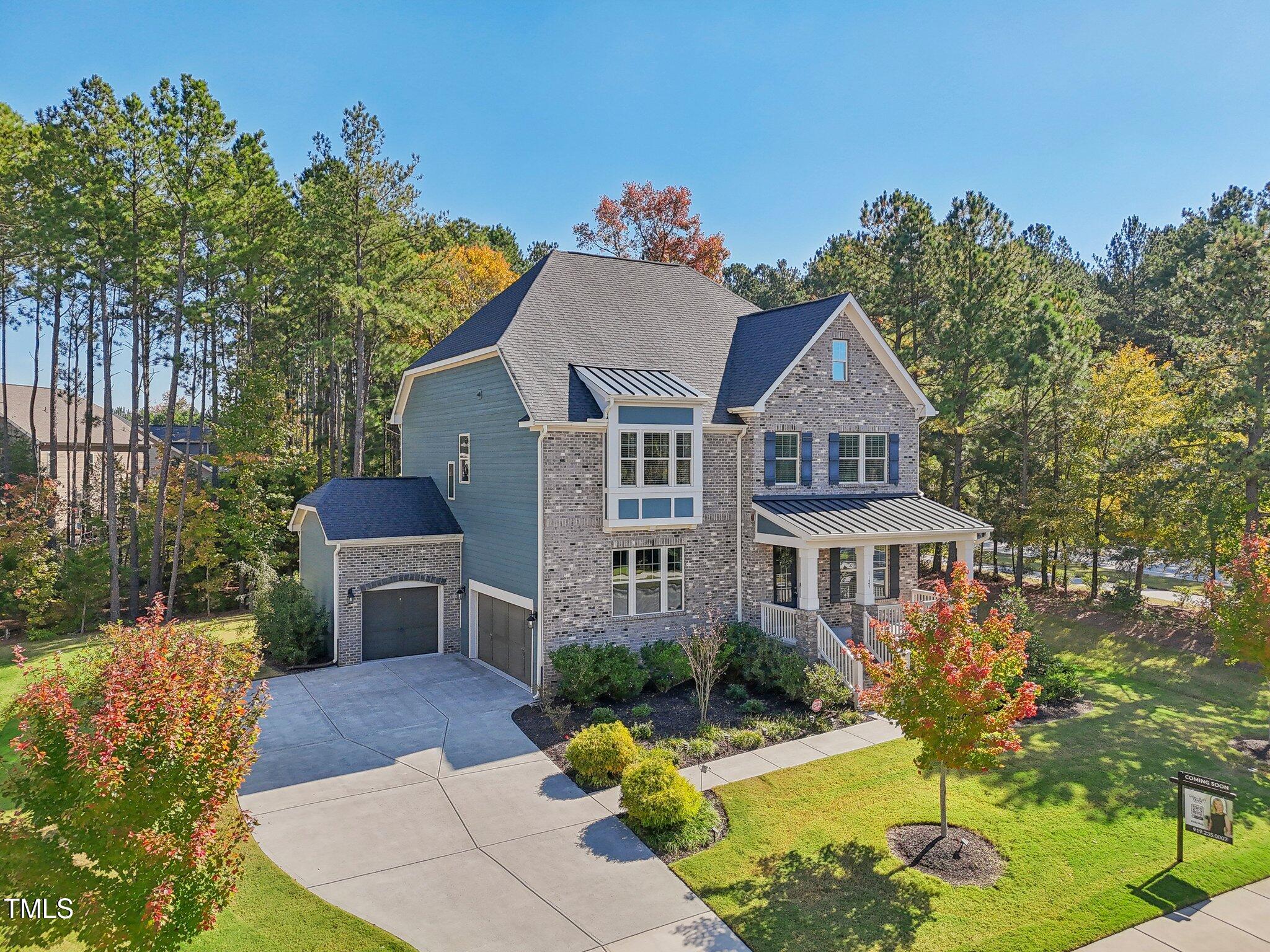 a front view of a house with a yard garage and outdoor seating