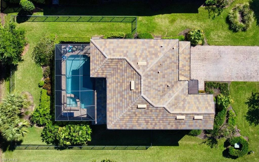 an aerial view of a house with a yard