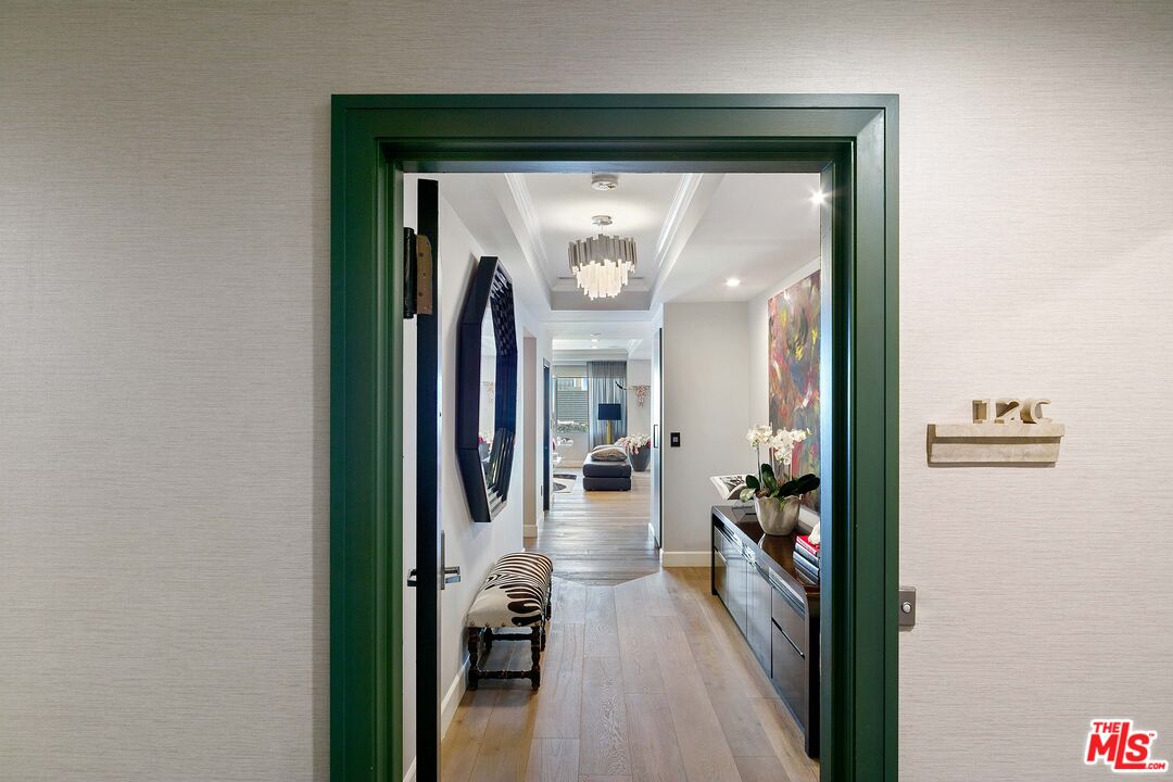 a view of a hallway and a livingroom with furniture