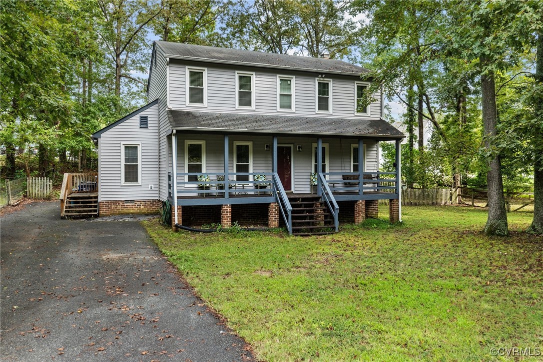 a view of a house with backyard porch and sitting area