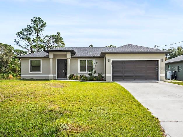 a front view of a house with yard and garage