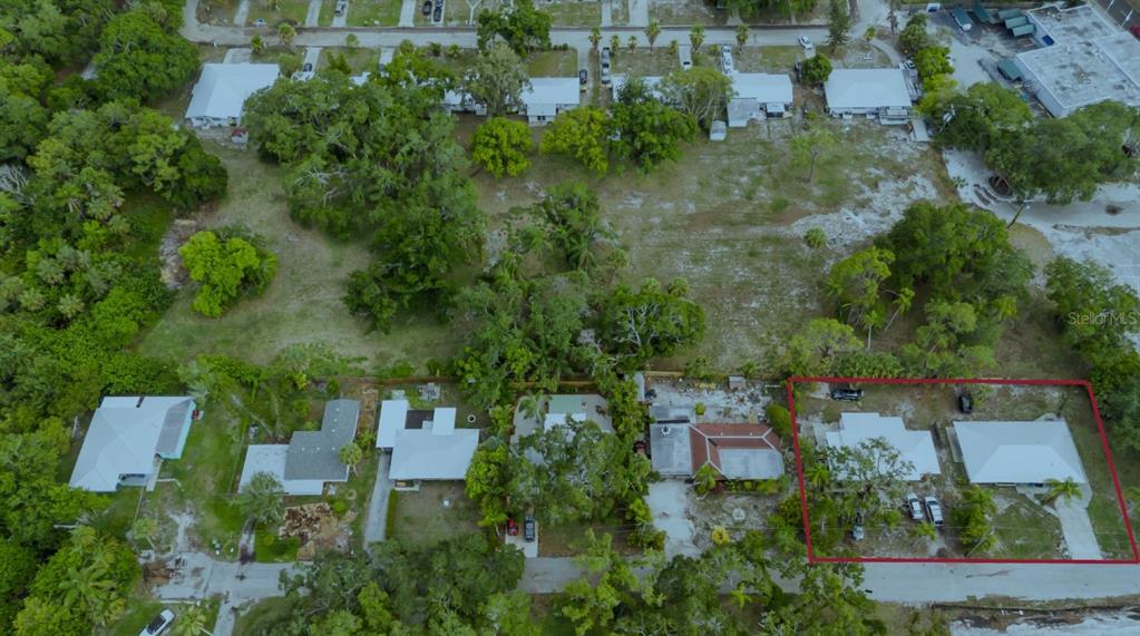 an aerial view of a house with a yard and lake view