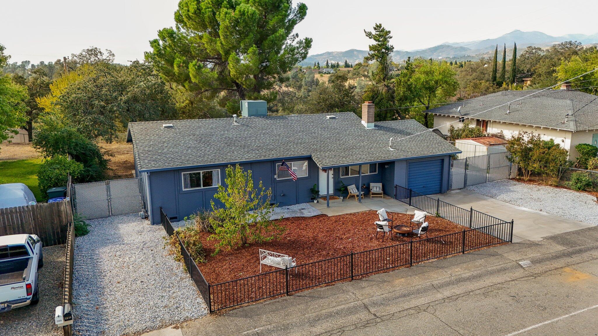 a view of a house with backyard and sitting area