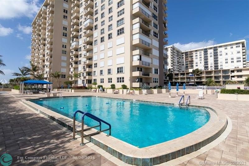 a view of a swimming pool with outdoor seating