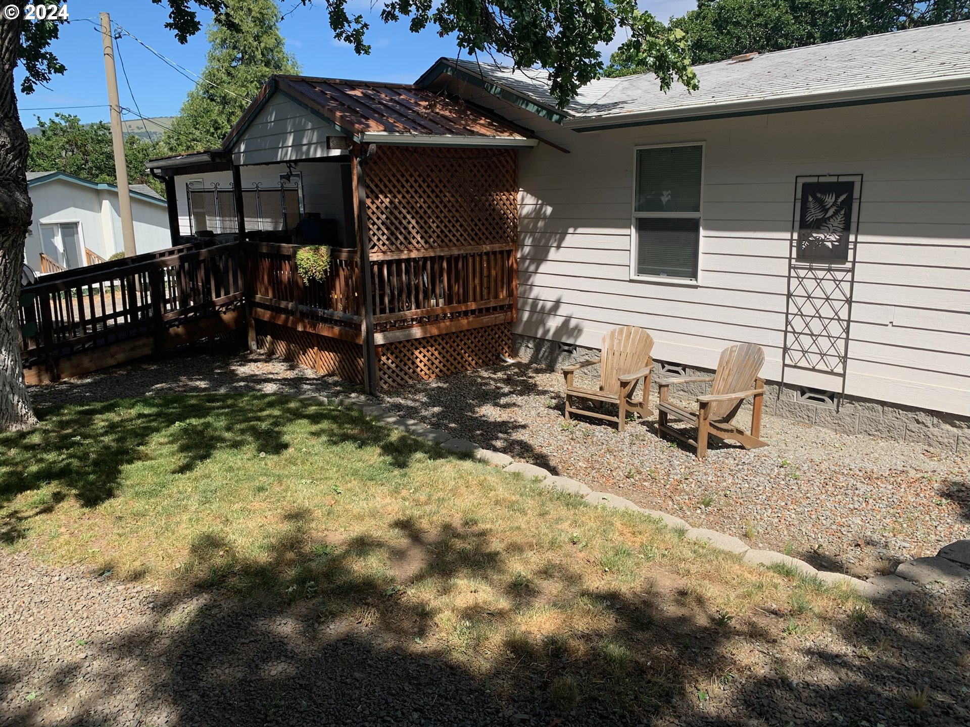 a view of a house with backyard and sitting area