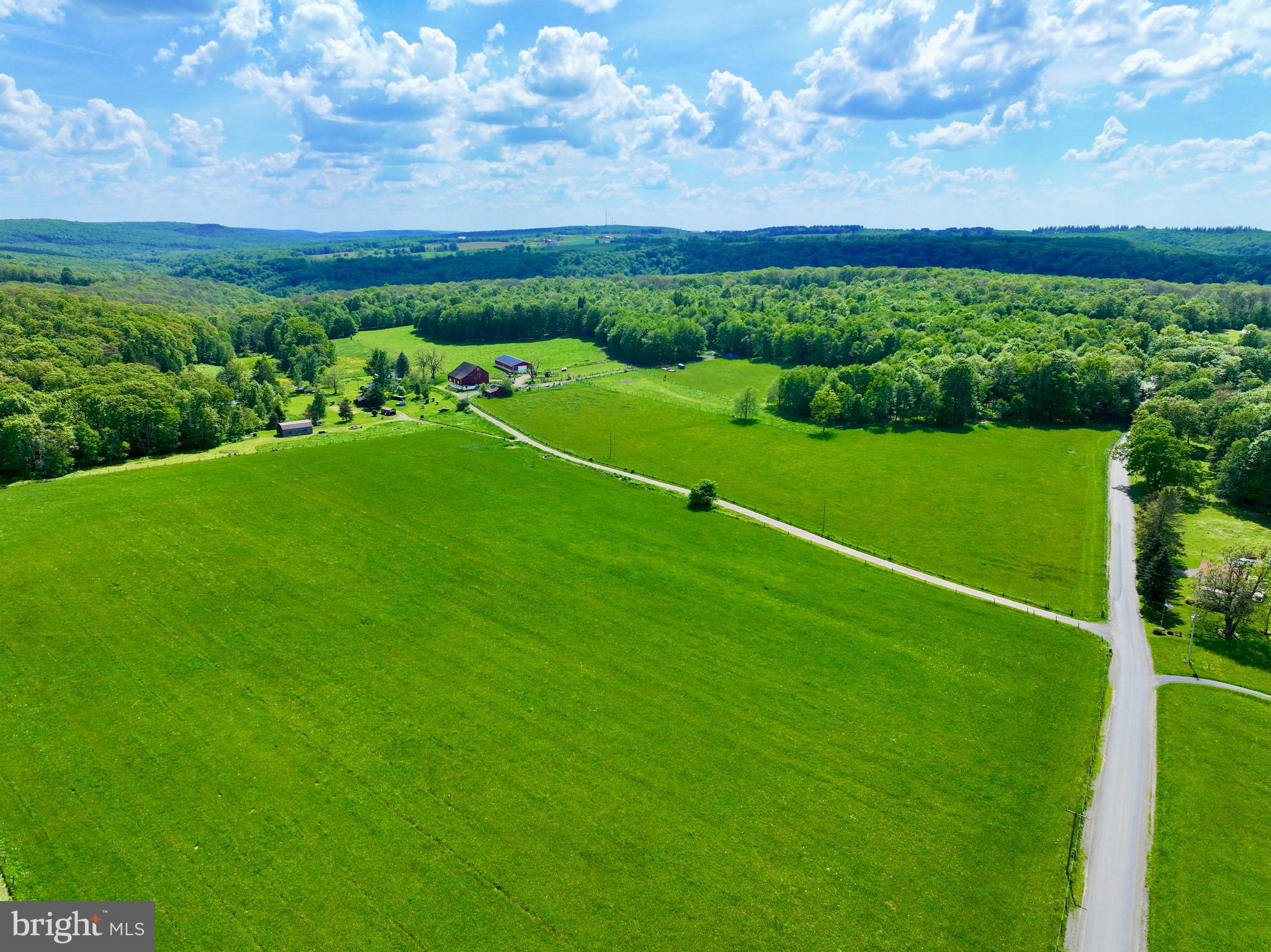 a view of a field with grass and a houses