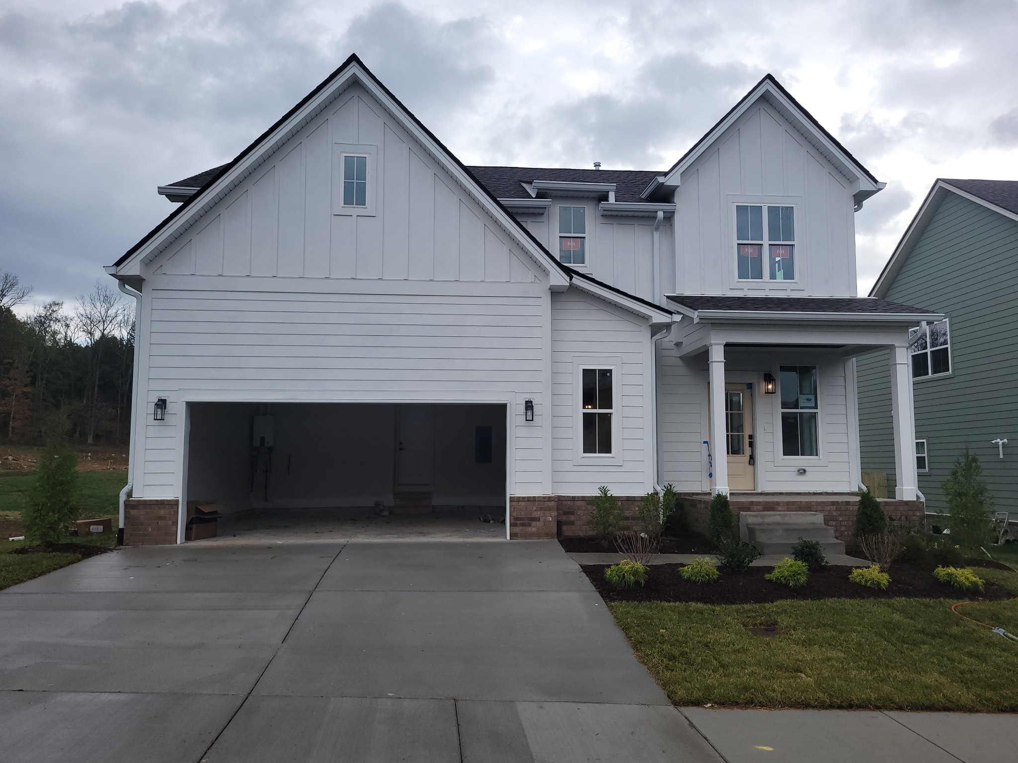 a front view of a house with a yard and garage