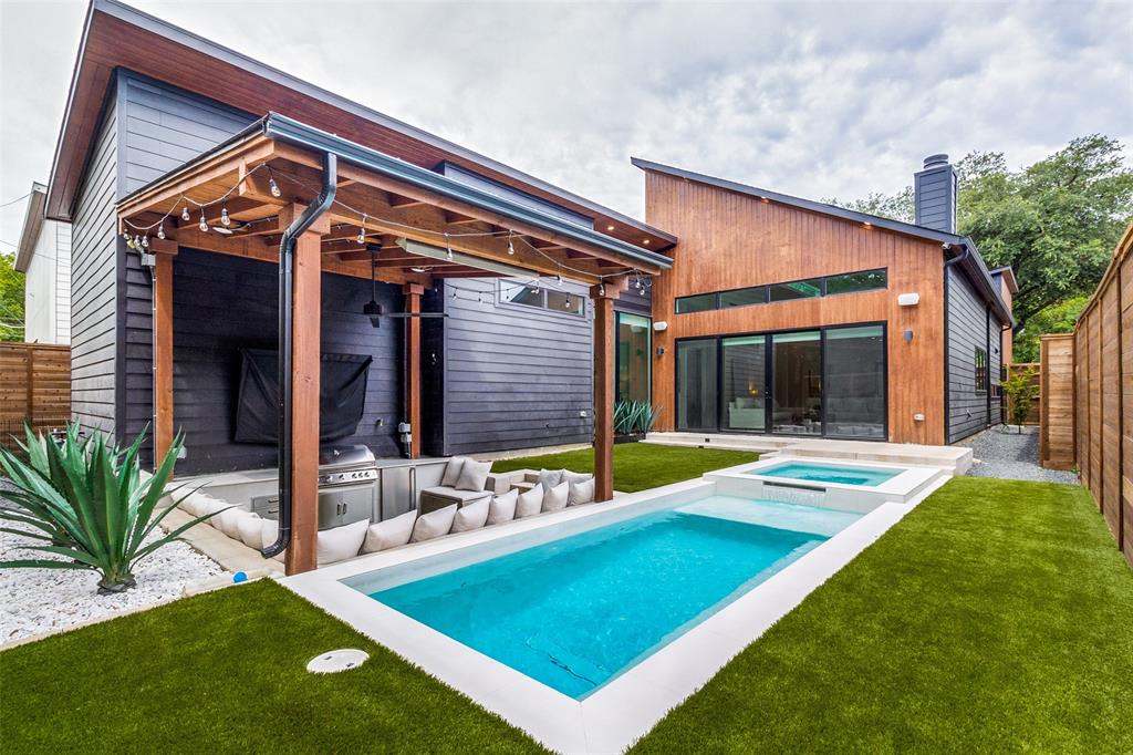 a view of an house with backyard porch and swimming pool