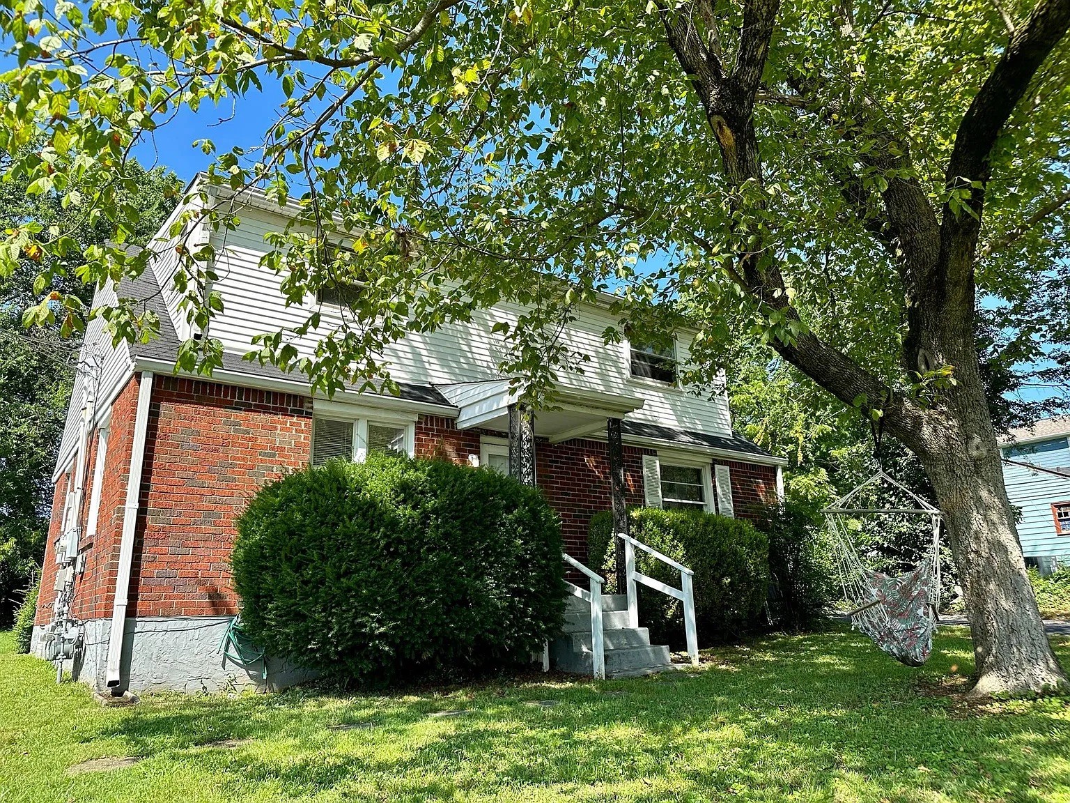 front view of a house with a tree