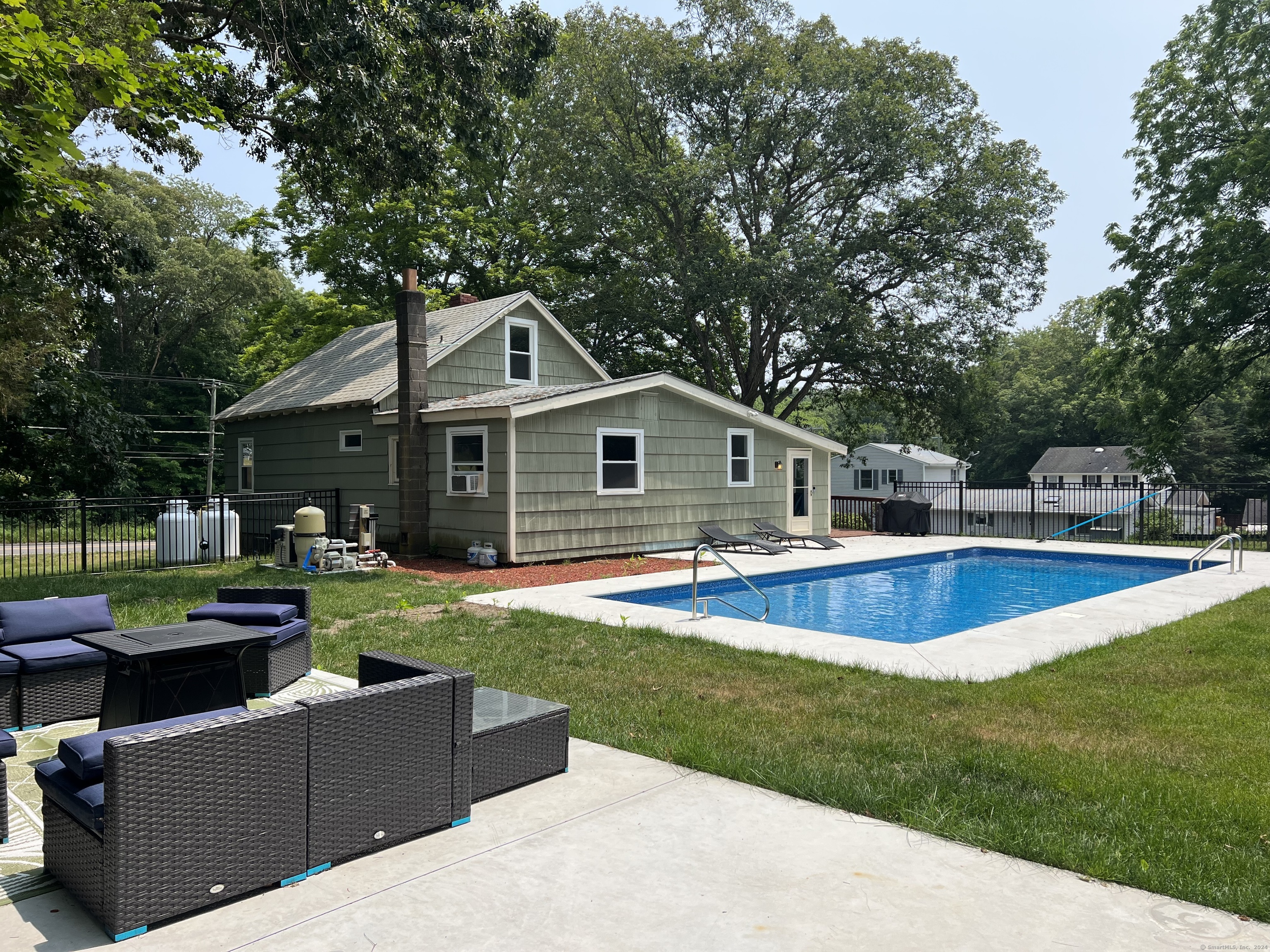 a view of a house with a yard patio and swimming pool