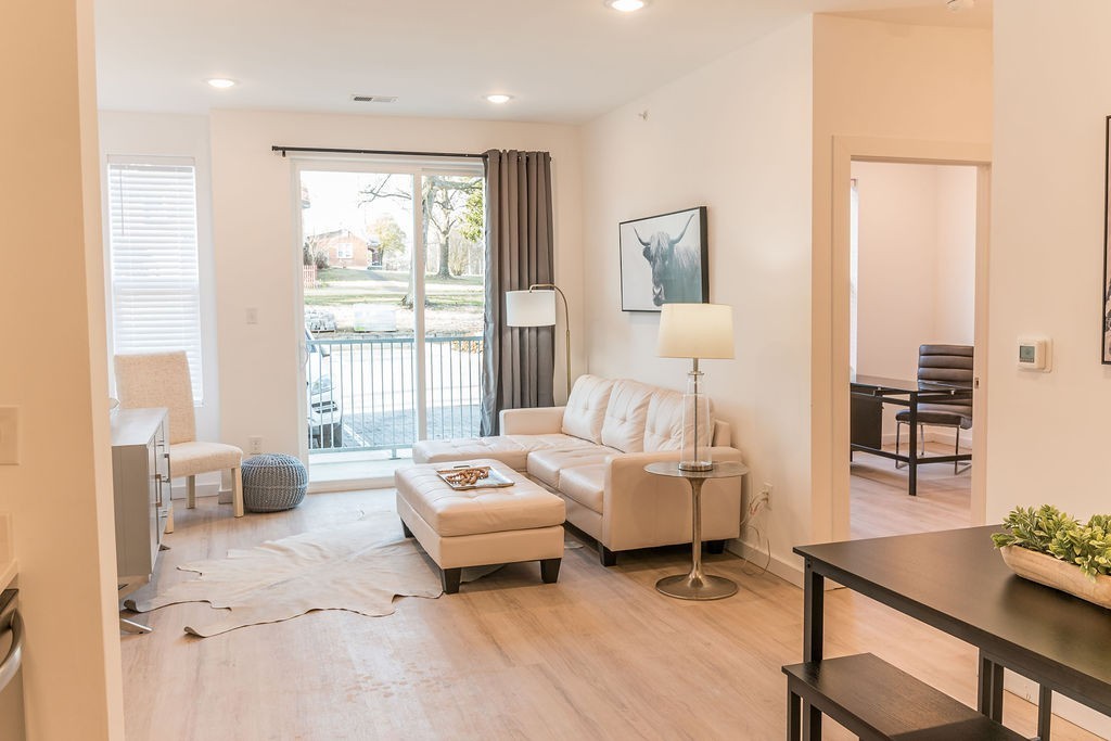 a living room with furniture and wooden floor