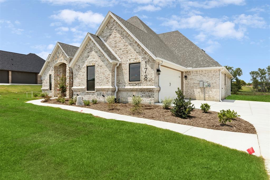 a front view of a house with a yard