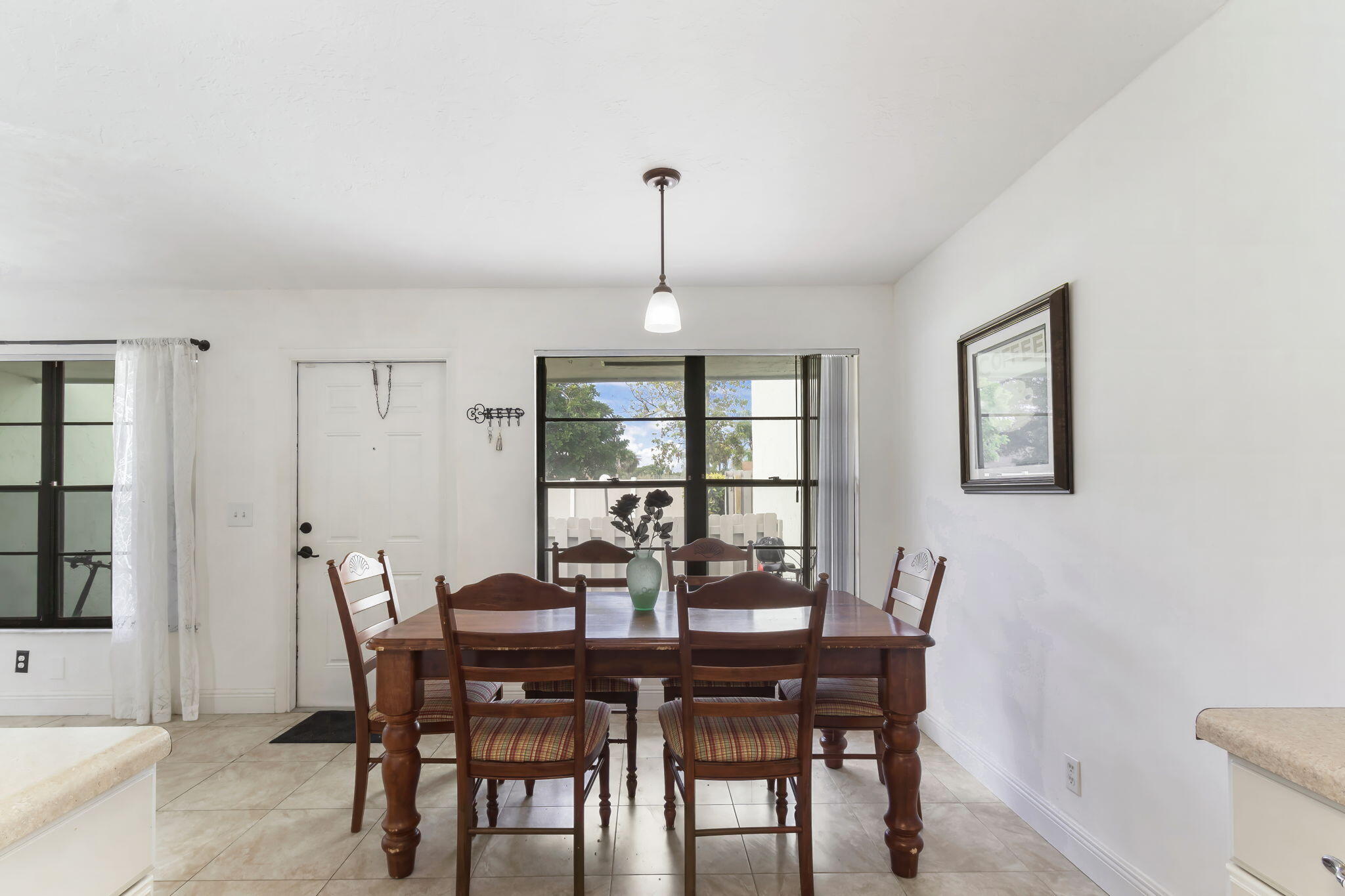 a view of a dining room with furniture and window