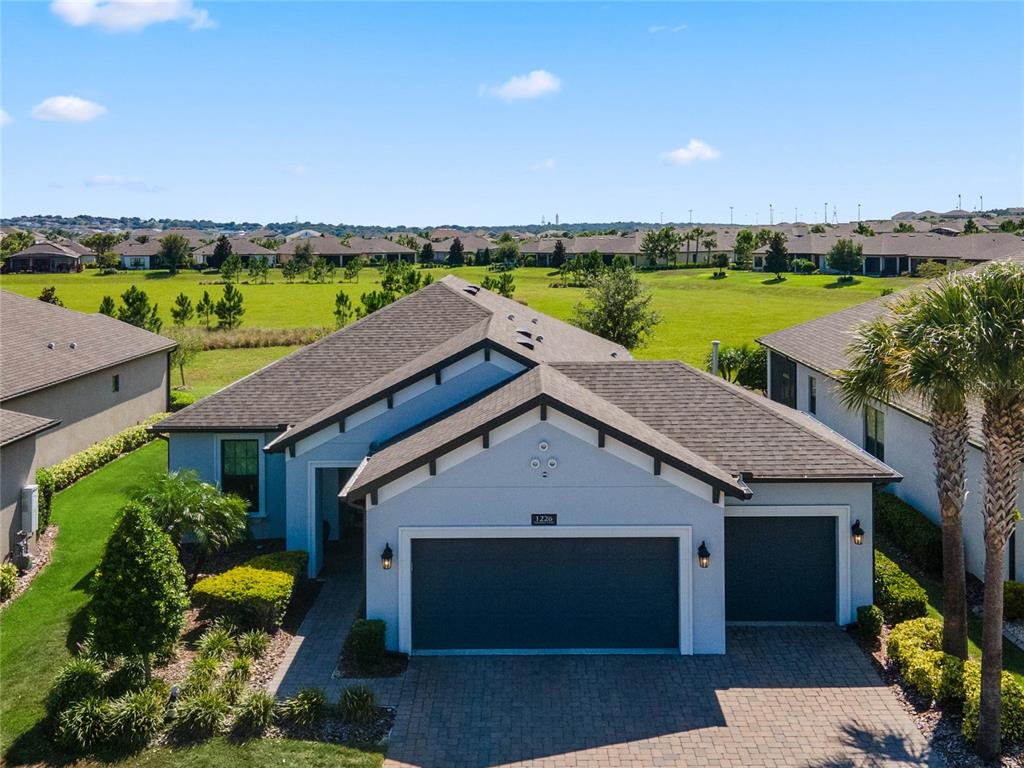 an aerial view of a house with a swimming pool outdoor seating and yard