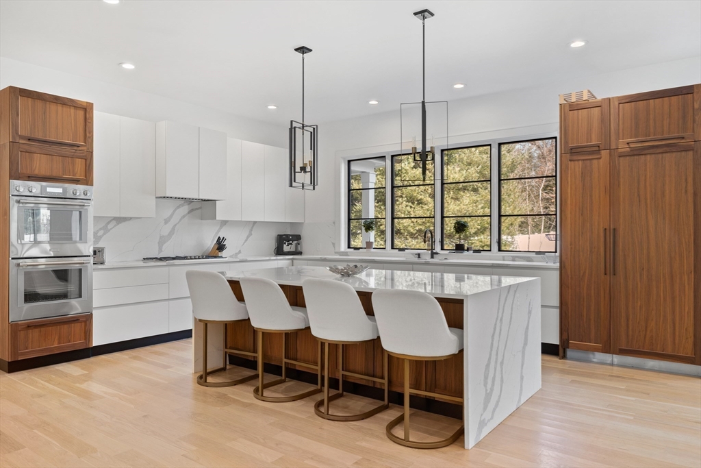 a kitchen with a table chairs sink and cabinets