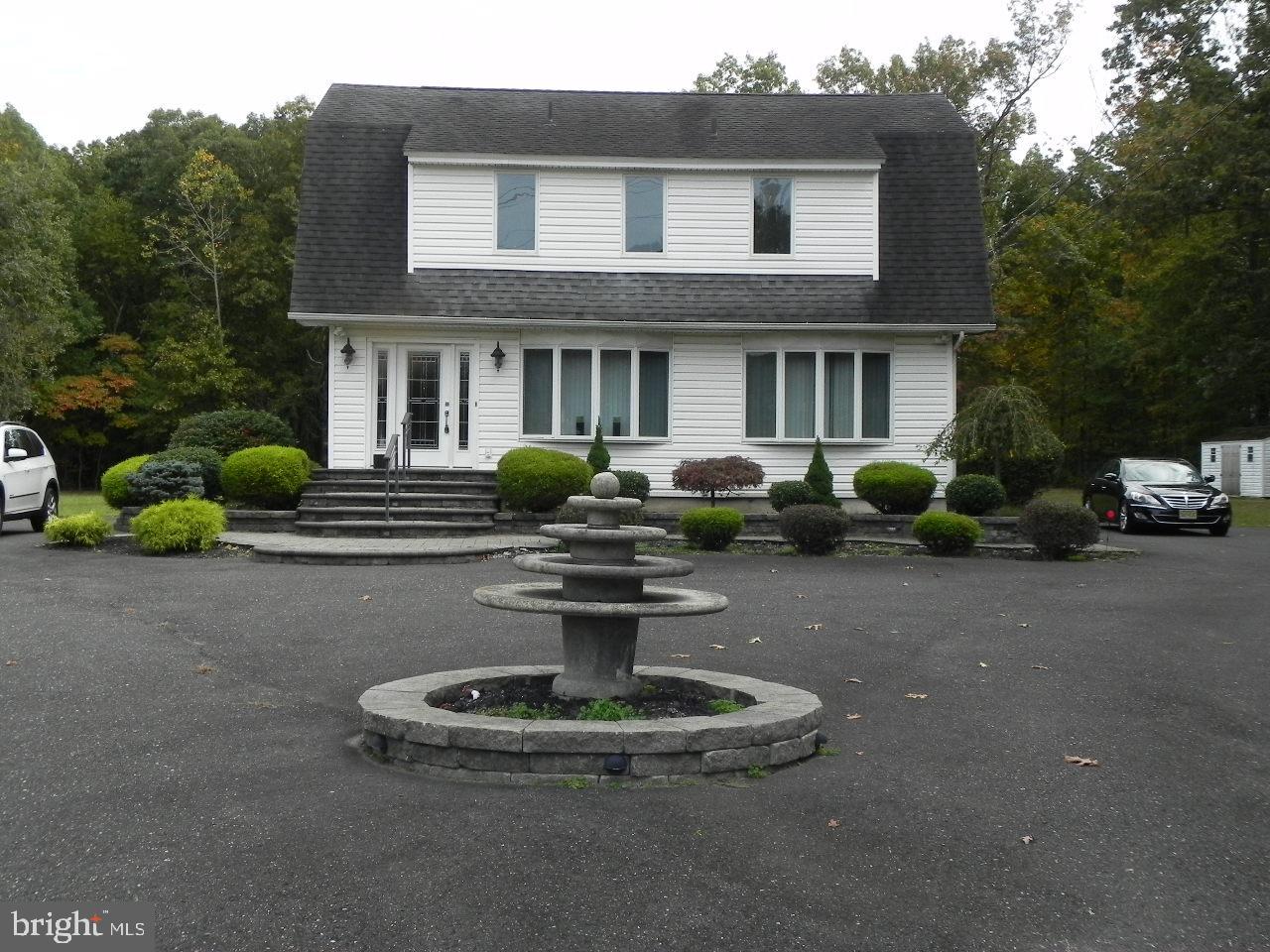 a front view of a house with sitting area