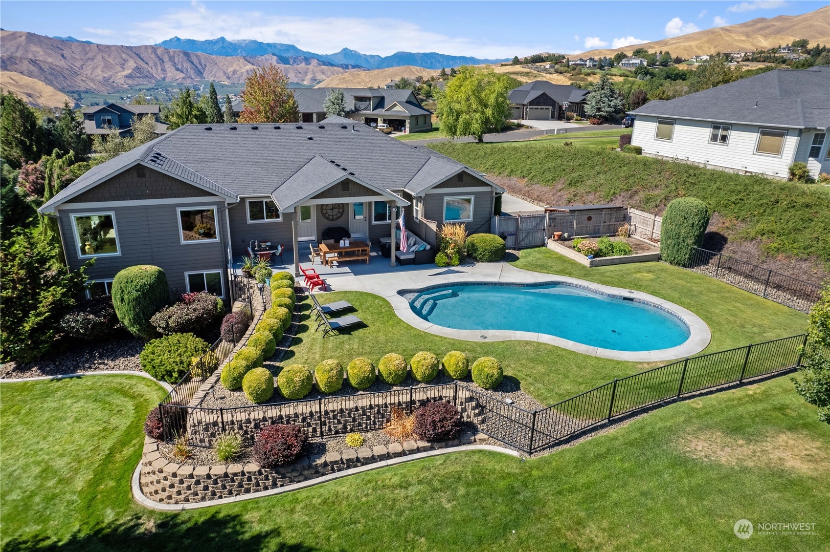 a view of a house with a swimming pool and a yard