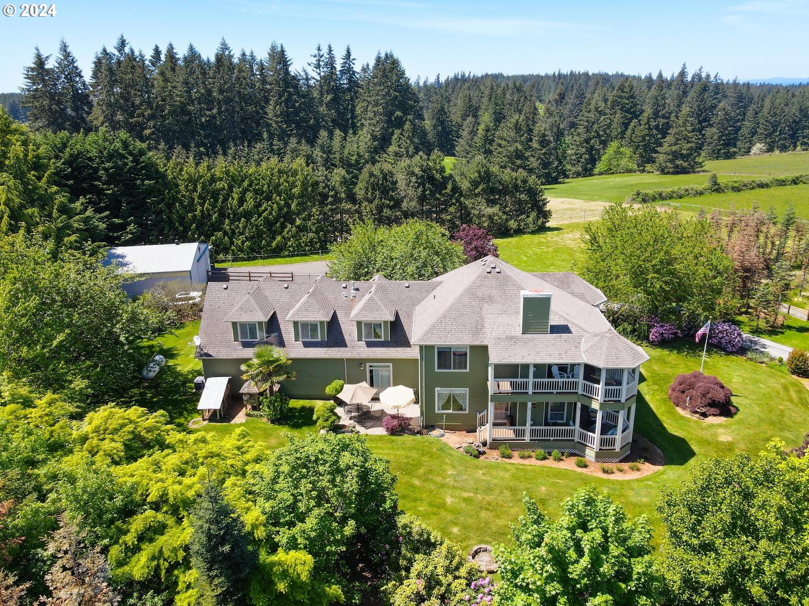 an aerial view of a house with swimming pool garden and outdoor seating