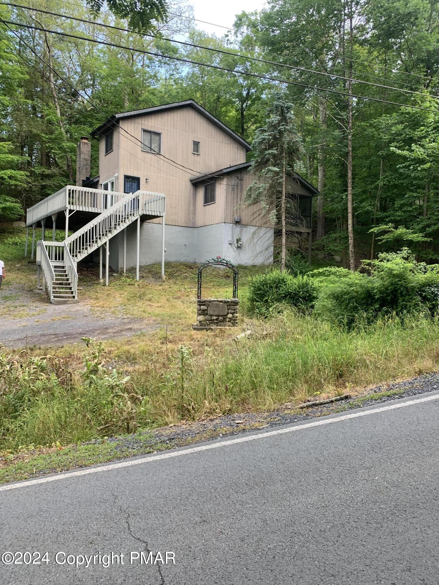 a view of house with backyard space and garden