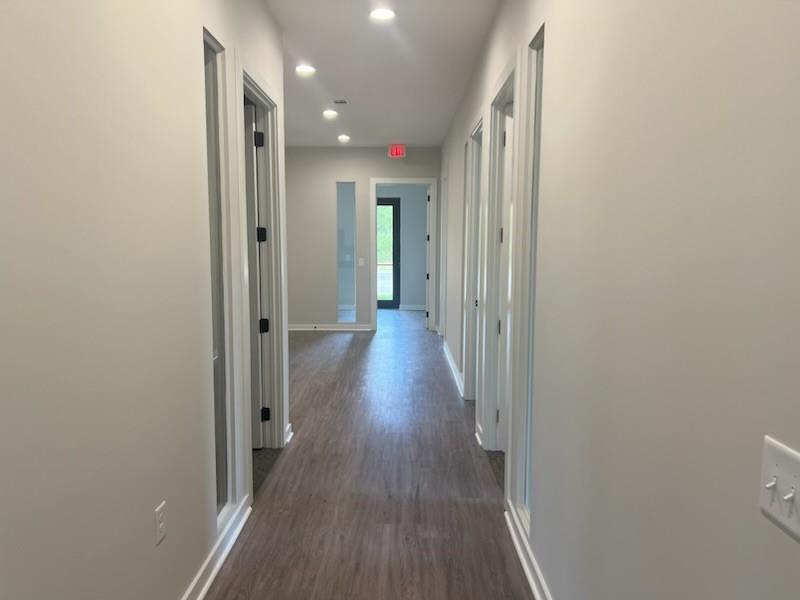 a view of a hallway with wooden floor