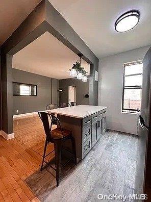 a kitchen with a dining table chairs and white cabinets