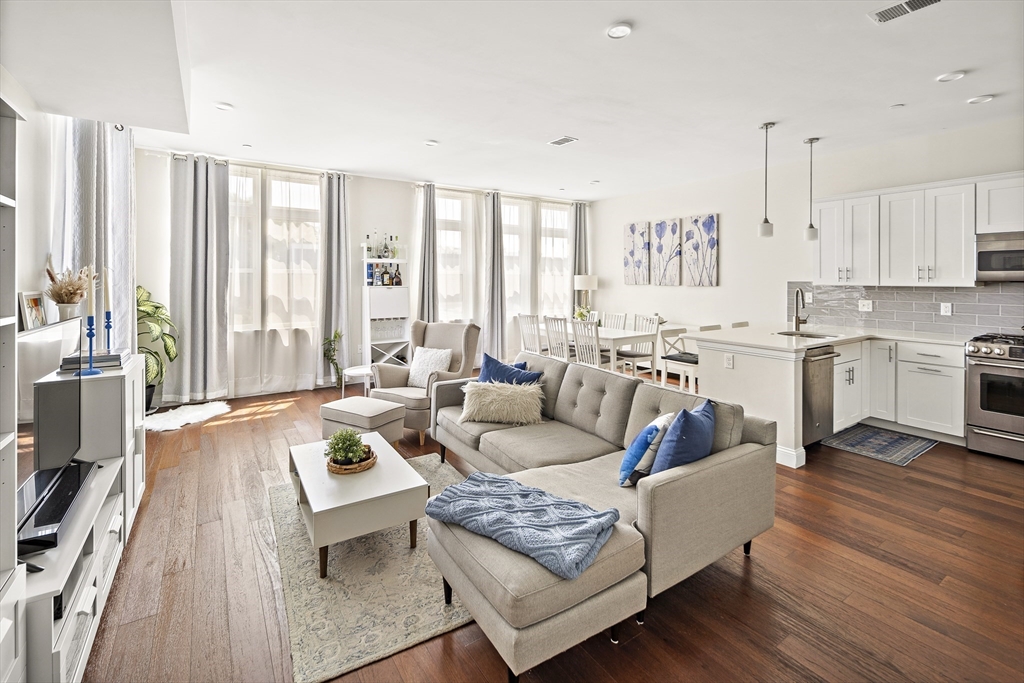 a living room with furniture and a large window