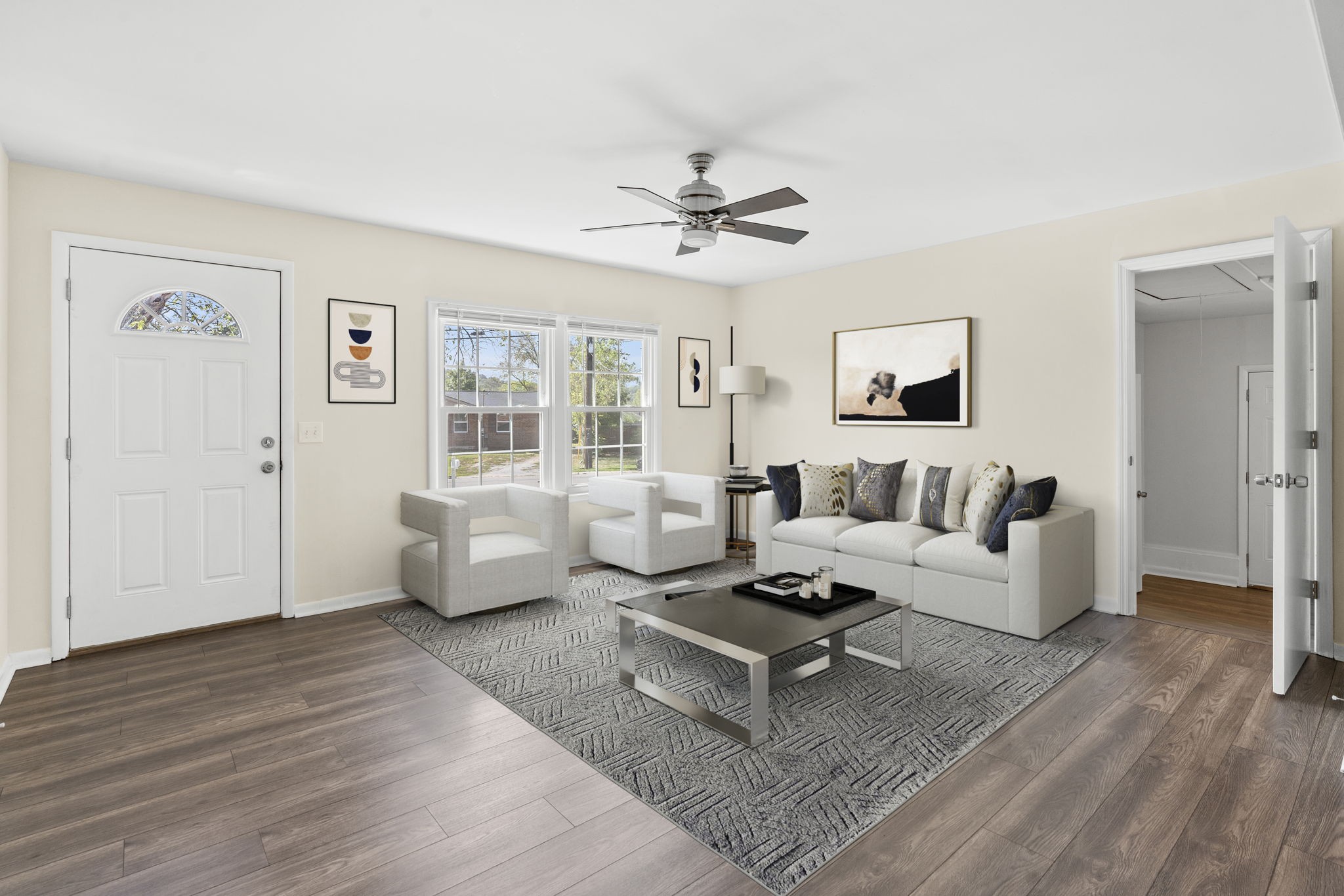 a living room with furniture and a wooden floor