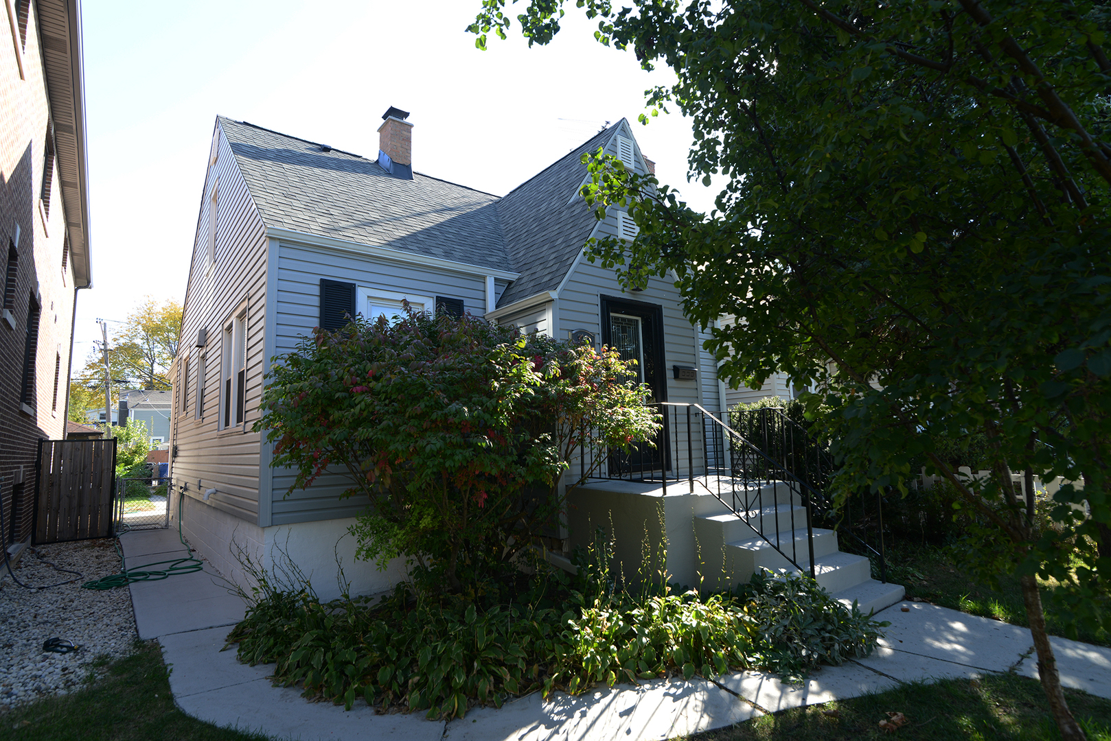 a front view of house with a garden