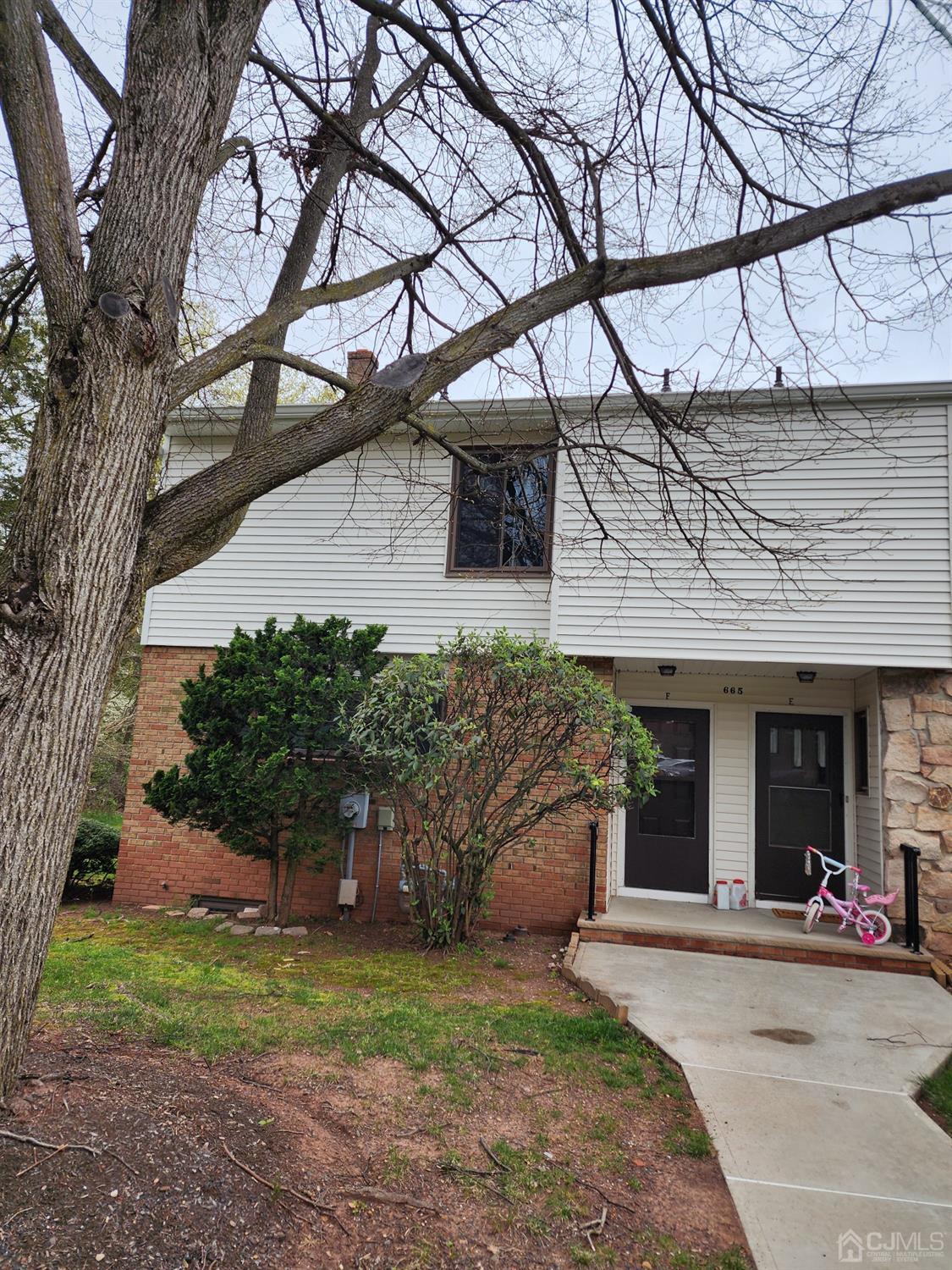 a front view of a house with a yard and a garage