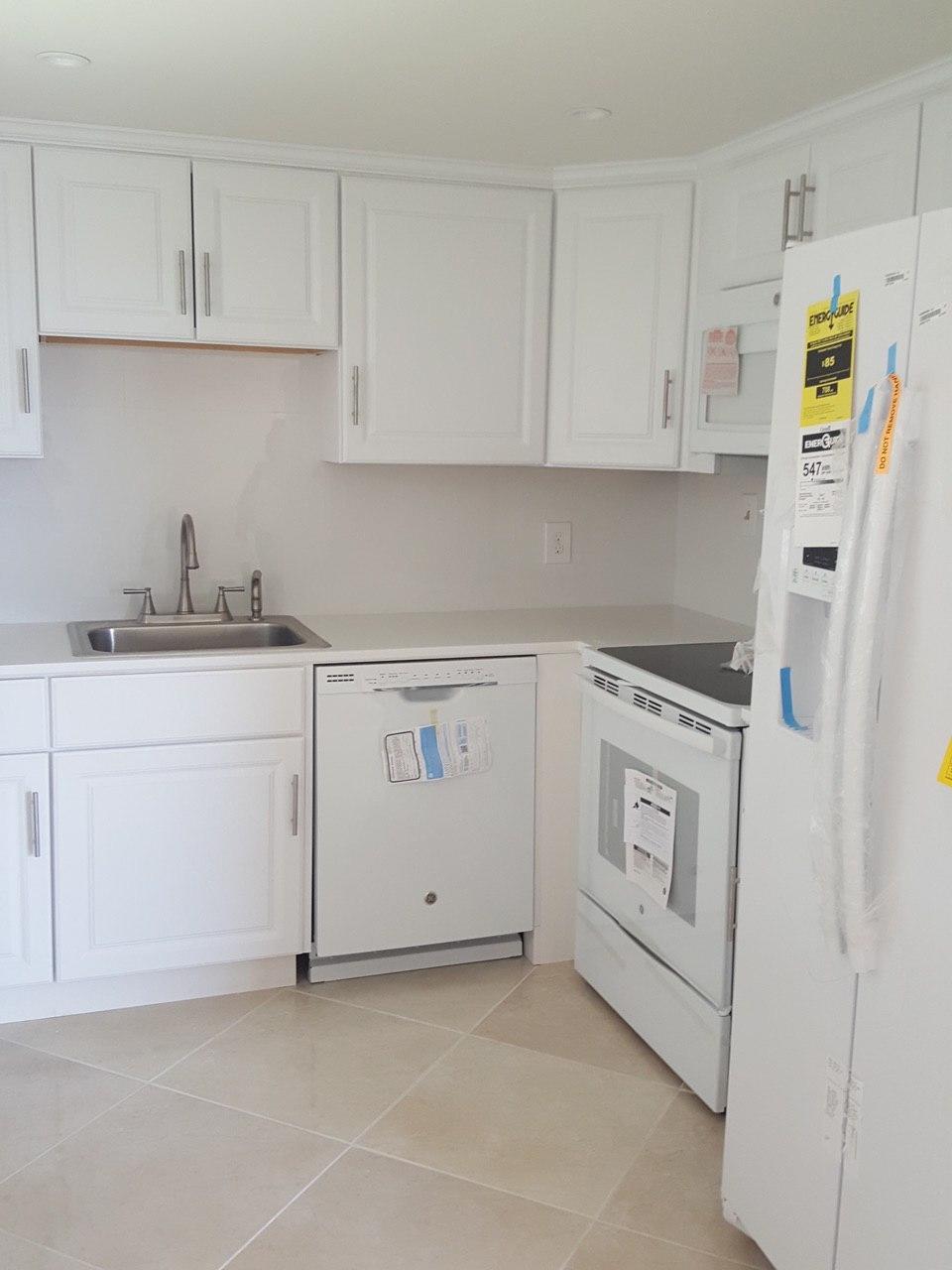 a kitchen with cabinets and appliances