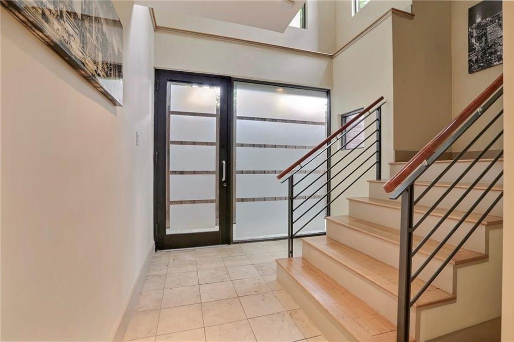 a view of staircase with white walls and a window