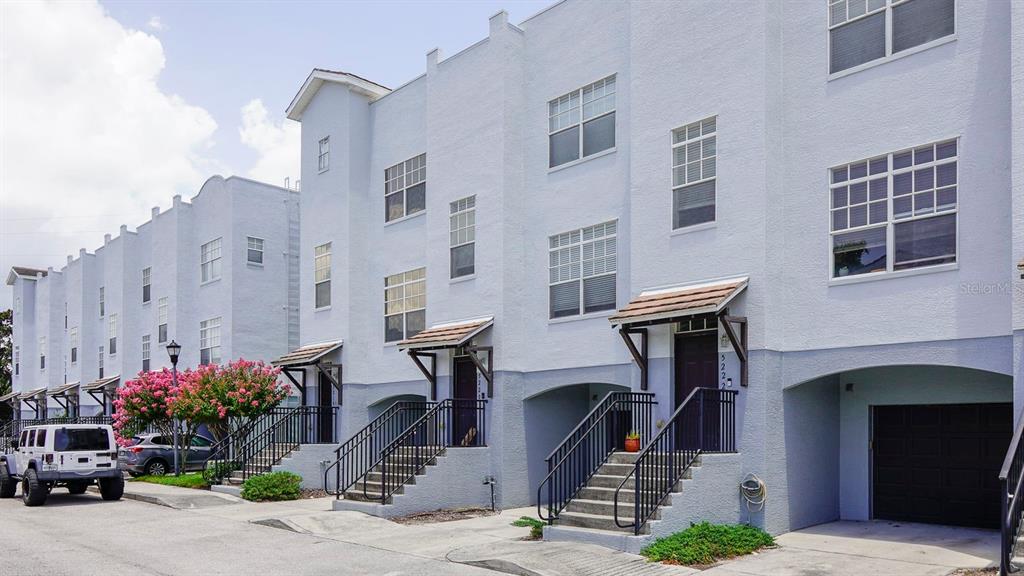 a front view of a building with potted plants